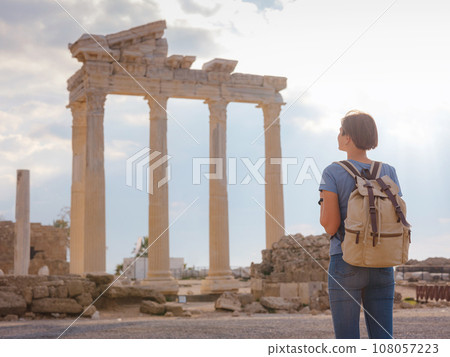 travel to ancient city of Side, Antalya coast of Turkey in tourist low season. Young tourist Asian woman is posing in front of temple of Apollo 108057223