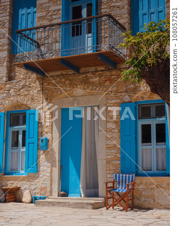 Cute details of windows, doors, balconies from old house in Simi island . Greece islands holidays from Rhodos in Aegean Sea. Colorful neoclassical houses in bay of Symi. Holiday travel background. 108057261