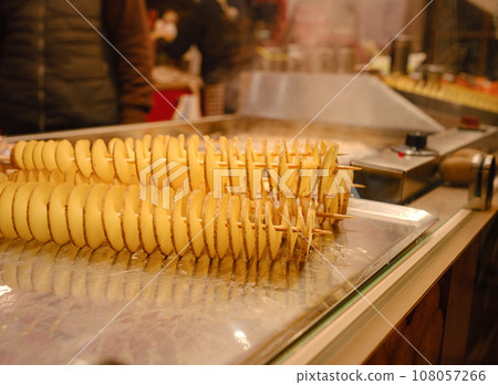 Dusselldorf, Germany - December 13, 2022: different types of christmas goodies at Christmas market in Dusselldorf, Germany. fried potatoes 108057266
