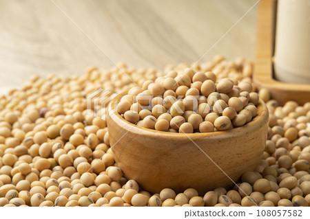 Soybean seeds in wooden bowl on wood table 108057582