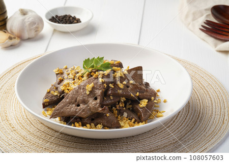 Fried Pork Liver with Garlic,Stir fry sliced liver with black peppercorn and garlic in white plate. 108057603