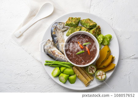 Spicy Shrimp Paste Dip (Nam Prik Kapi) served with Fried Egg with Climbing Wattle, fried mackerel fish and boiled vegetable.Top view 108057652