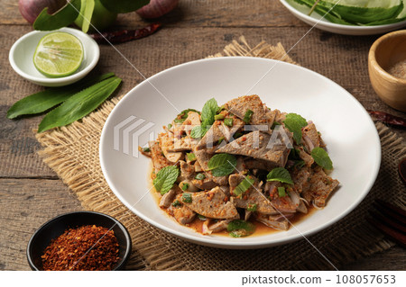 Spicy Pork Liver Salad (Tub Wan) in white plate.Thai food Spicy Pork Liver Salad (Tub Wan) in white plate.Thai food 108057653