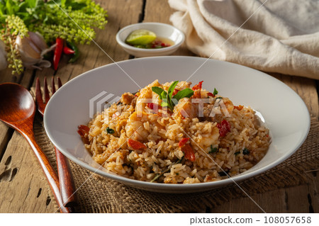 Spicy Shrimp and minced pork Fried Rice with thai holy basil leaves in white plate. Spicy Shrimp and minced pork Fried Rice with thai holy basil leaves in white plate. 108057658