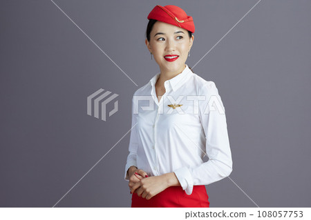 happy asian female flight attendant looking at copy space 108057753