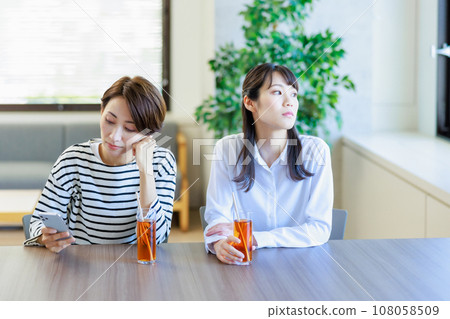 Slanted young woman in a good mood at a cafe Slanted young woman in a good mood at a cafe 108058509