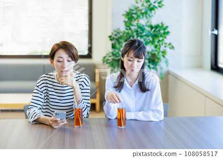 Slanted young woman in a good mood at a cafe 108058517