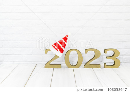 2023 new year and christmas hat on white wood table over white background  with copy space 108058647