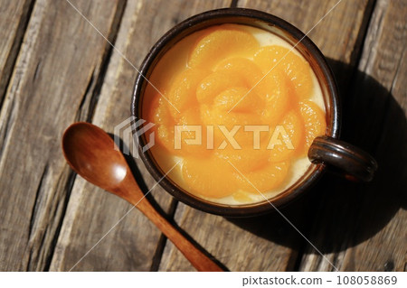 Yogurt jelly decorated with mandarin oranges served on Japanese tableware Yogurt jelly decorated with mandarin oranges served on Japanese tableware 108058869