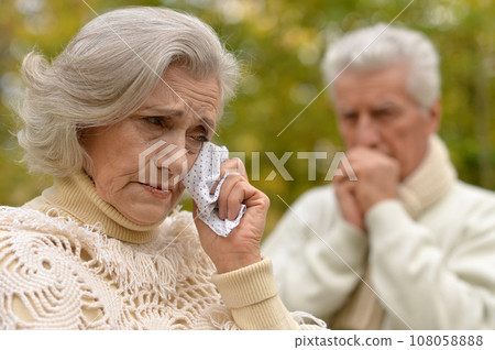 Portrait of sad senior couple in autumn park Portrait of sad senior couple in autumn park 108058888