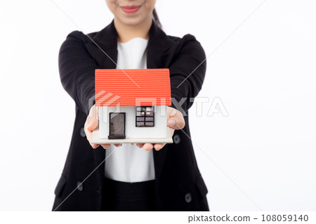 Closeup hands young asian businesswoman holding house for mortgage isolated. 108059140