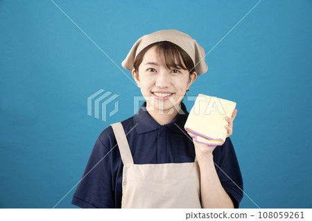 Female house cleaning worker with handy mop against blue background 108059261