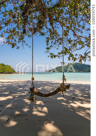 Wooden swing on beautiful white sand beach, Surin island national park, Phang nga, Thailand Wooden swing on beautiful white sand beach, Surin island national park, Phang nga, Thailand 108059743