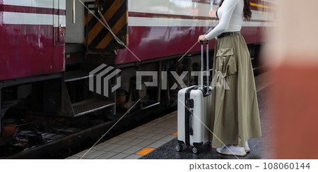 Alone Asian woman traveler with suitcase in train station platform. Summer vacation holiday and travel concept 108060144