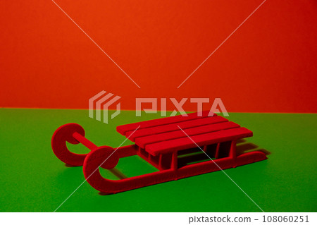 Red sledge Minimalistic concept in isometric style in red and green colors. Copy space for text. Decorative red sleds for mock-up. Trendy product stand display showcase for different products and 108060251