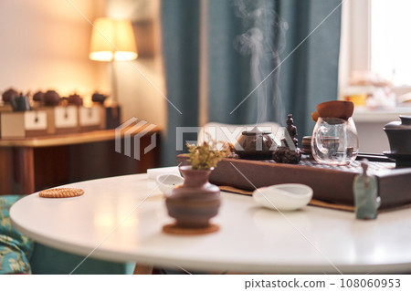 Tea master pours white tea to guests. Everything is ready for the tea ceremony. The ceremony is according to all the rules, but not in the classical style. Adapted to a modern apartment. 108060953