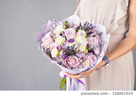 Small Beautiful bouquet of mixed flowers in woman hand. Floral shop concept . Beautiful fresh cut bouquet. Flowers delivery Small Beautiful bouquet of mixed flowers in woman hand. Floral shop concept . Beautiful fresh cut bouquet. Flowers delivery 108061024