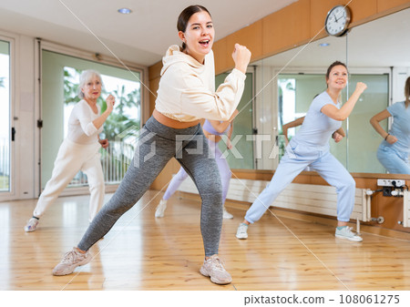 Positive people practicing vigorous lindy hop movements in dance class Positive people practicing vigorous lindy hop movements in dance class 108061275