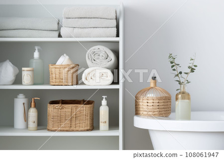 Corner of the bathroom cabinet. Shelving unit and baskets with clean towels and toiletries. Generative AI 108061947