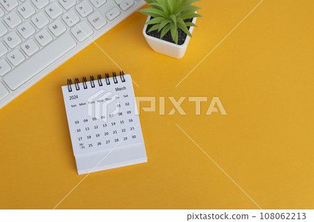 March 2024 desk calendar on yellow background. Directly above. Flat lay. March 2024 desk calendar on yellow background. Directly above. Flat lay. 108062213