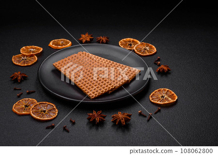 Delicious sweet crispy rectangular waffles on a ceramic plate Delicious sweet crispy rectangular waffles on a ceramic plate 108062800