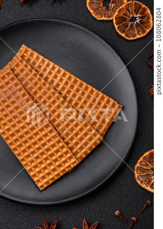 Delicious sweet crispy rectangular waffles on a ceramic plate Delicious sweet crispy rectangular waffles on a ceramic plate 108062804