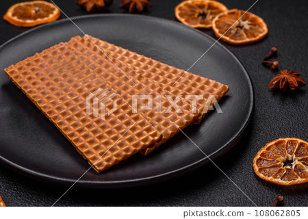 Delicious sweet crispy rectangular waffles on a ceramic plate Delicious sweet crispy rectangular waffles on a ceramic plate 108062805