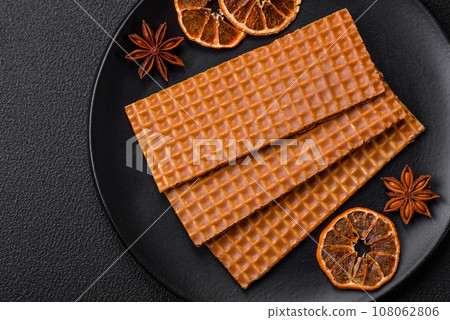 Delicious sweet crispy rectangular waffles on a ceramic plate Delicious sweet crispy rectangular waffles on a ceramic plate 108062806