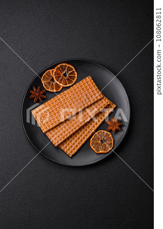 Delicious sweet crispy rectangular waffles on a ceramic plate Delicious sweet crispy rectangular waffles on a ceramic plate 108062811
