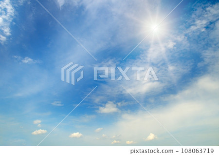 Blue sky , sun and beautiful white clouds. 108063719