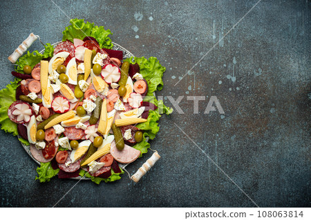 Close up of Fiambre, salad of Guatemala, Mexico and Latin America top view with cold cuts and pickled vegetables. Festive dish for All Saints Day (Day Of The Dead) celebration, space for text Close up of Fiambre, salad of Guatemala, Mexico and Latin America top view with cold cuts and pickled vegetables. Festive dish for All Saints Day (Day Of The Dead) celebration, space for text 108063814