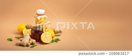 Composition with detox drink, sea buckthorn berries, lemons, mint, ginger, honey in glass jar. Food for immunity stimulation and against flu. Healthy natural remedies to boost immune system Composition with detox drink, sea buckthorn berries, lemons, mint, ginger, honey in glass jar. Food for immunity stimulation and against flu. Healthy natural remedies to boost immune system 108063817