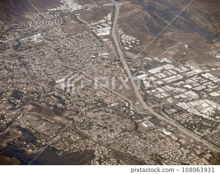 Highway stretches through LA and Mountains 108063931