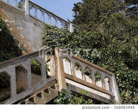 Decaying Staircase up retaining wall 108063948