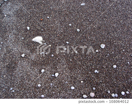 Smooth rocks and dark large sand 108064012