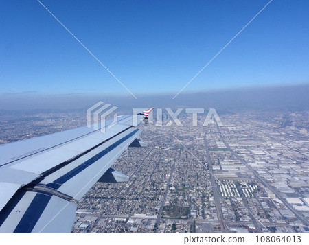 Looking out at a Airplane Wing with View of Downtown LA Looking out at a Airplane Wing with View of Downtown LA 108064013