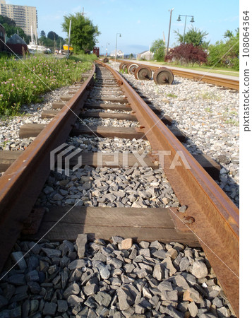 Railroad tracks running into distance with through Portland, Maine 108064364