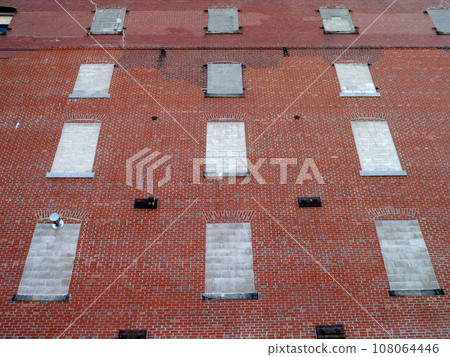 Red Brick building with Cemented in Windows 108064446