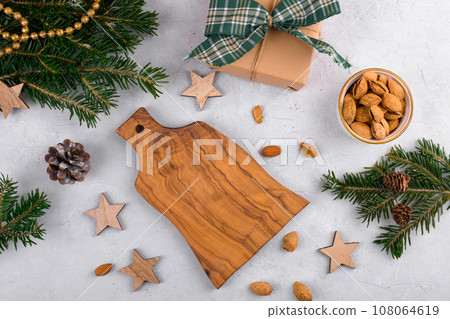 Cutting board podium for object with Christmas decoration and natural fir branch on light background 108064619