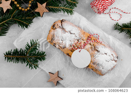 Christmas stollen with gift tag is traditional festive German bread, Holiday pastry dessert 108064623