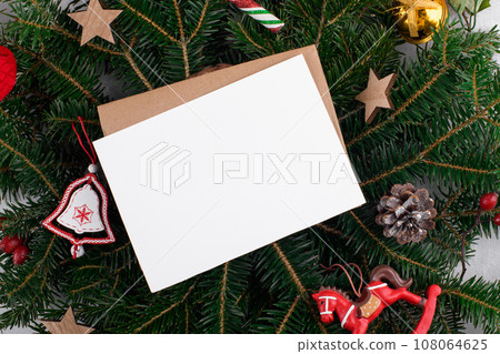 Christmas 5x7 card mockup template with envelop on natural fir branch background Christmas 5x7 card mockup template with envelop on natural fir branch background 108064625