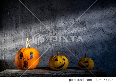 scary funny Halloween pumpkins on wooden table scary funny Halloween pumpkins on wooden table 108065492
