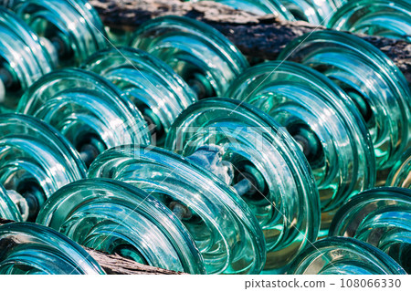 Glass transparent high-voltage insulator is in storage. Industrial background. 108066330