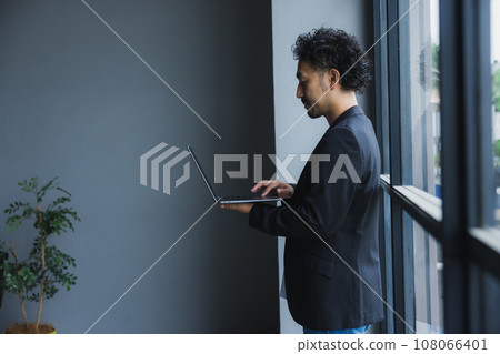 Computer, smartphone, bearded man Computer, smartphone, bearded man 108066401
