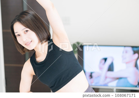 Young woman taking online lessons in the living room 108067171