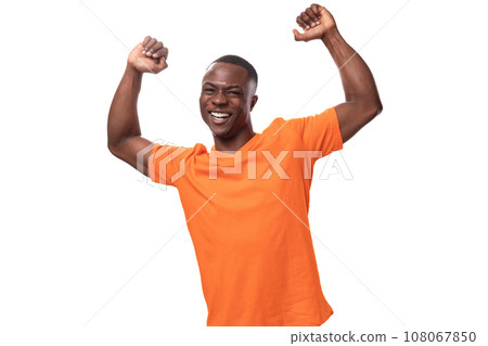 young charismatic positive American guy with a short haircut dressed in an orange T-shirt on a white 108067850