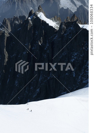 Two Mountaineers on Snow in the Mountains in French Alps. Two Mountaineers on Snow in the Mountains in French Alps. 108068334