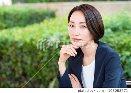 Business woman relaxing on the terrace Business woman relaxing on the terrace 108068471