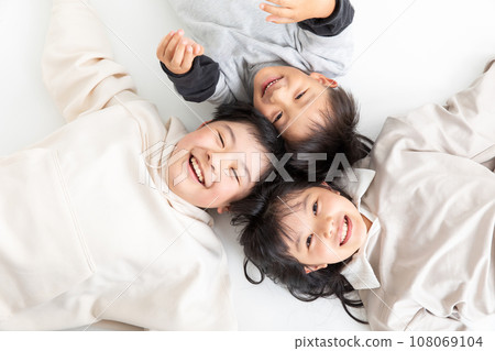 Children lying down with smiles: three brothers Children lying down with smiles: three brothers 108069104