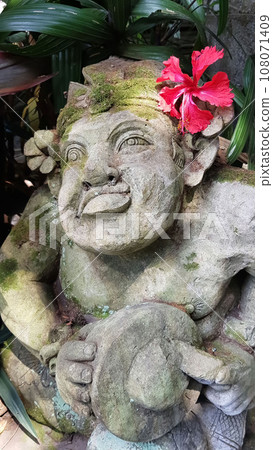 Beautiful artistic Bali stone statue of a Balinese ancient garden statue used as garden decoration, javanese gnome indonesia Beautiful artistic Bali stone statue of a Balinese ancient garden statue used as garden decoration, javanese gnome indonesia 108071409